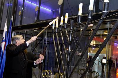 President of Slovenia Dr Danilo Trk lights a candle on Jewish candelabrum Hanukkiyah at the Hanukkah 5772 ceremony (photo: Stanko Gruden/STA)